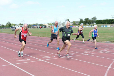 men running on athletic track
