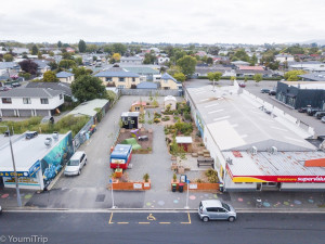 An aerial view of a plot of land featuring sheds and garden spaces