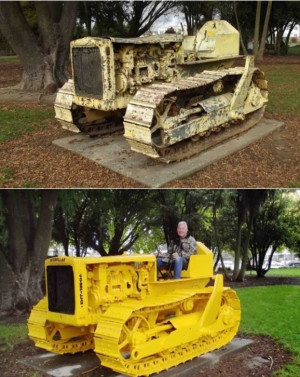 A man sits atop a bright yellow bulldozer in a park
