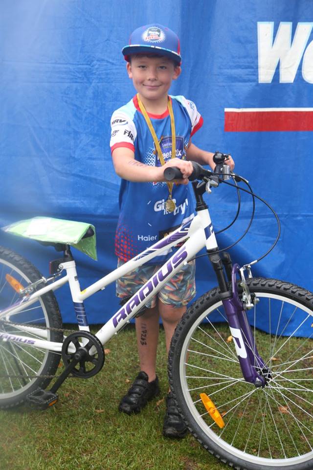 Young male participant in a previous Sanitarium Weet-Bix Kids TRYathlon with his bike.