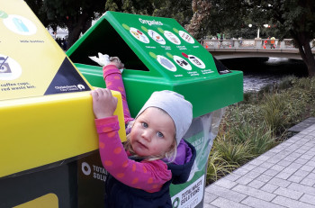 Child putting recycling into the bin