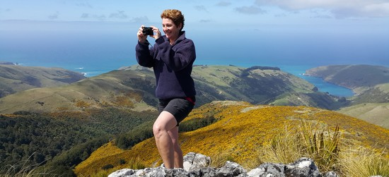 person looking out from top of peak