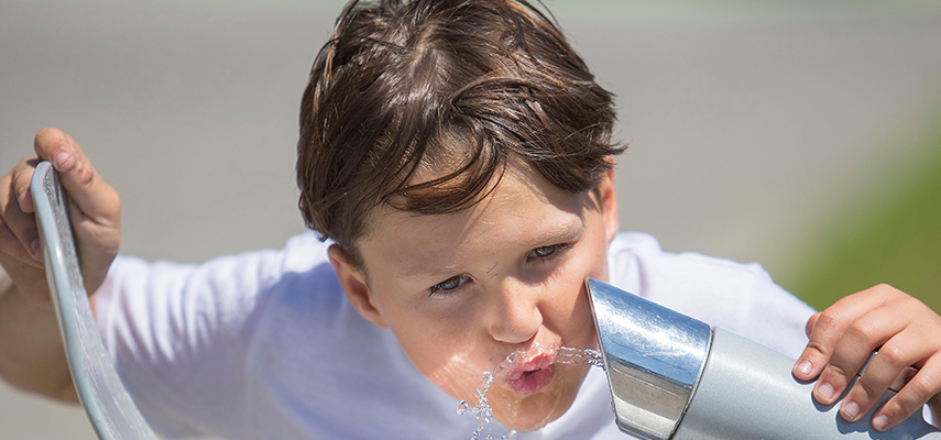 Child drinking from drinking fountain