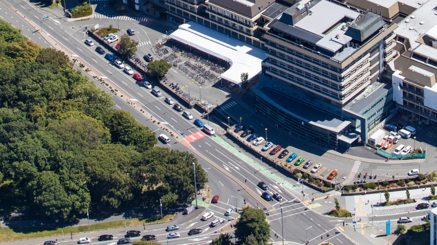 An aerial image of Hospital Corner, which is where Hagley Avenue and Riccarton Avenue meet, outside Christchurch Hospital. Hagley Park is on the left of the image and the Hospital is on the right 